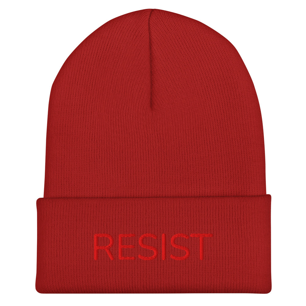 A red knitted hat with the word RESIST embroidered in red thread